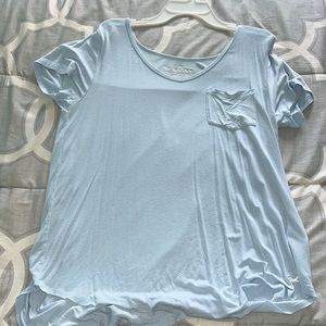 A lightweight, cute light blue top. Brand is Hollister, size medium, fits long.